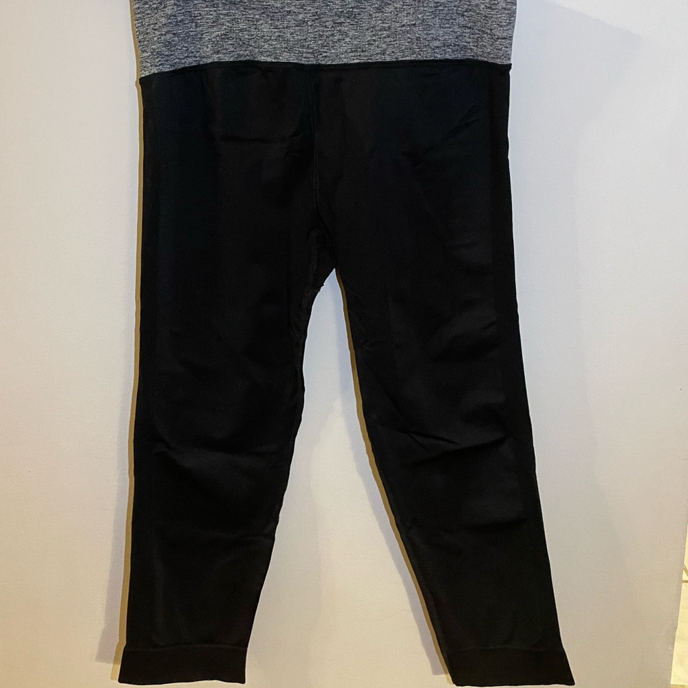 Black athletic leggings with gray strap